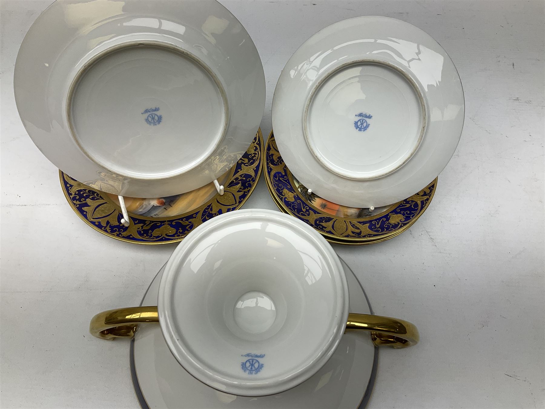 Noritake tea service for four, decorated with desert camel scene with blue border and gilding, comprising four teacups and saucers, four side plates, lidded sucrier, teapot and jug, together with twin handled pedestal bowl etc (19 pcs) 