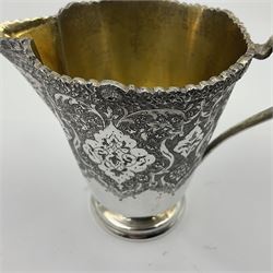Early/mid 20th century Persian silver tea service, comprising circular serving tray, teapot, twin handled sucrier and cover, milk jug, five tea glasses with six silver holders, six tea spoons, and pair of sugar tongs, each profusely chased with foliate arabesque decoration, each bearing marks including 84 for 840 fineness, tray D40cm, teapot H16cm