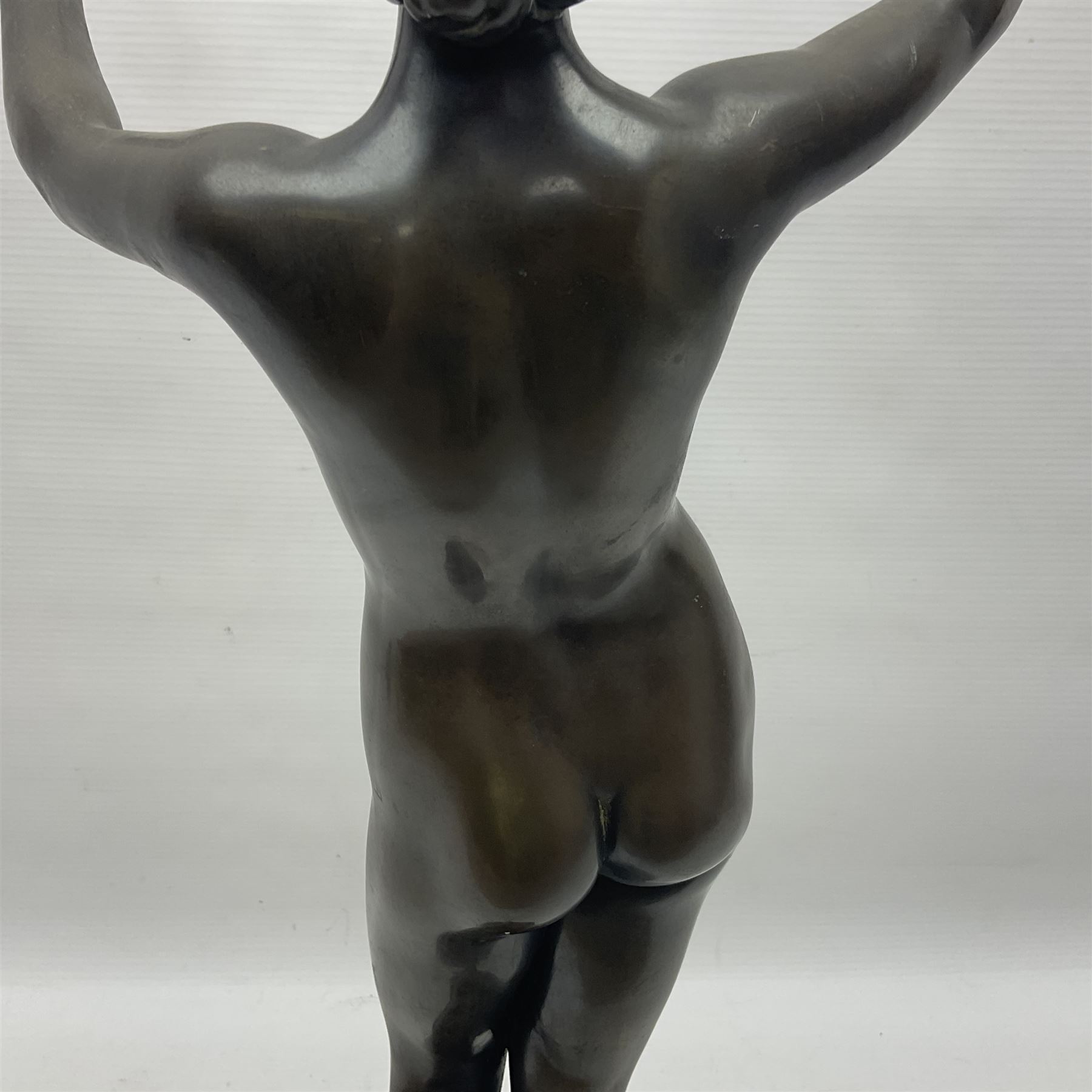 After Eugen Schlipf, Fanfair, bronzed female figure playing two horns, upon a circular marble plinth, H57cm