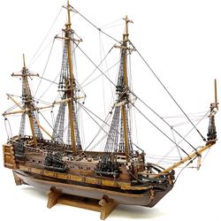 Kit built model of a three masted sailing ship, with rigging, upon a wooden stand, L69cm, H63cm