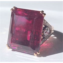 Rose gold rubellite tourmaline and diamond ring, the central octagonal step cut tourmaline of 43.25 carat, with a round brilliant cut diamond set either side and diamond set shoulders by Judith Crowe, hallmarked 9ct, the two large side diamonds total 2.10 carat, with World Gemological Institute report