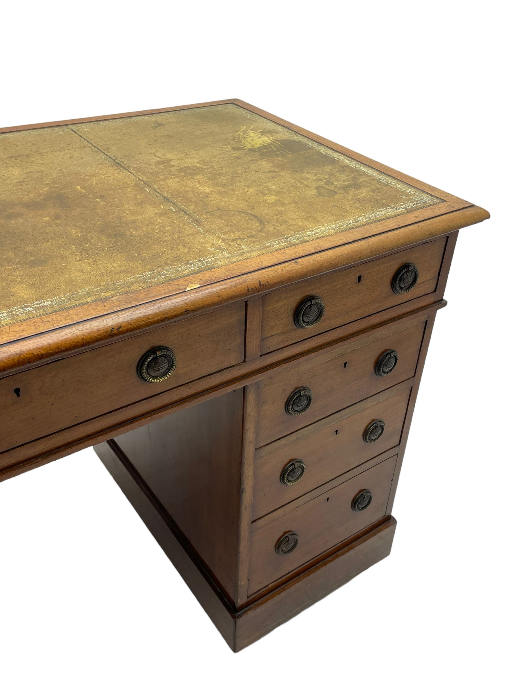 Howard & Sons. - 19th century walnut twin pedestal desk, moulded rectangular top with tooled leather inset, fitted with nine drawers with circular pressed brass handle plates decorated with urns, each drawer fitted with a 'Hobbs, London' lock, on plinth base, the upper right-hand drawer stamped 'Howard & Sons, Berners St.' and with paper label