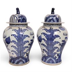 Pair of blue and white Chinese vase and cover, of baluster form, decorated with dragons, the cover with a fo dog finial, H15cm