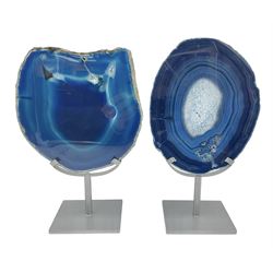 Pair of blue agate slices, polished with rough edges, raised upon silvered metal stands, H26cm