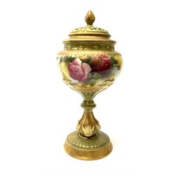 A Royal Worcester potpourri vase and cover, shape 1813, the bulbous body hand painted with pink roses and signed A Watkins, supporting a gilded and burnished pierced cover, upon a moulded stem with zoomorphic mask detail and circular foot, with puce printed mark beneath, H24cm