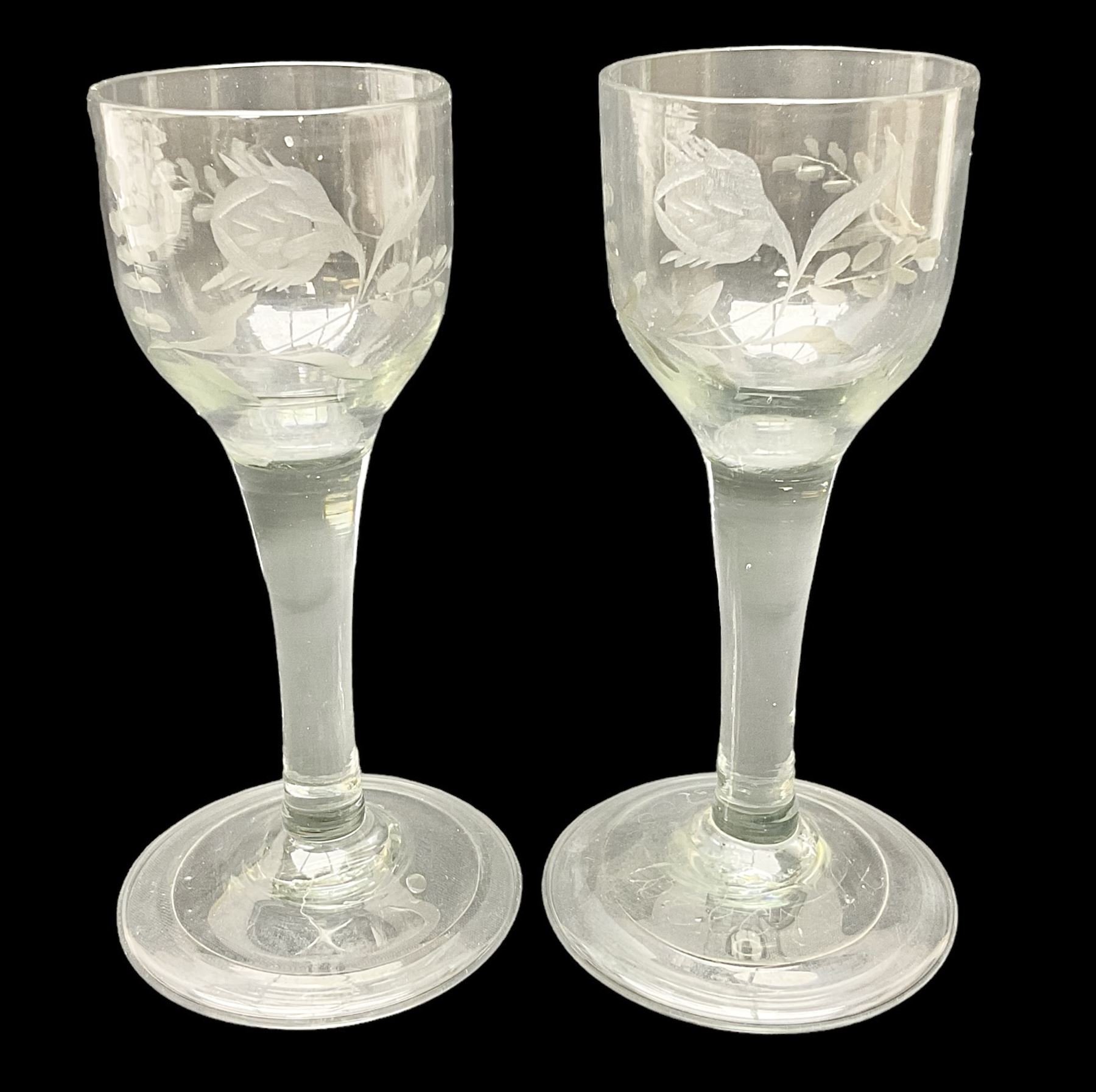 Pair of 18th century Jacobite style wine glasses, the ogee shaped bowls engraved with a single rose and sprig, plain stems upon conical folded feet H13cm