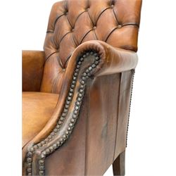 Laura Ashley - hardwood-framed armchair, traditional shape with arched cresting rail over rolled arms, upholstered in buttoned brown leather with studded work, on turned front feet (W76cm, W95cm, D84cm); together with matching rectangular footstool (53cm x 34cm, H29cm)