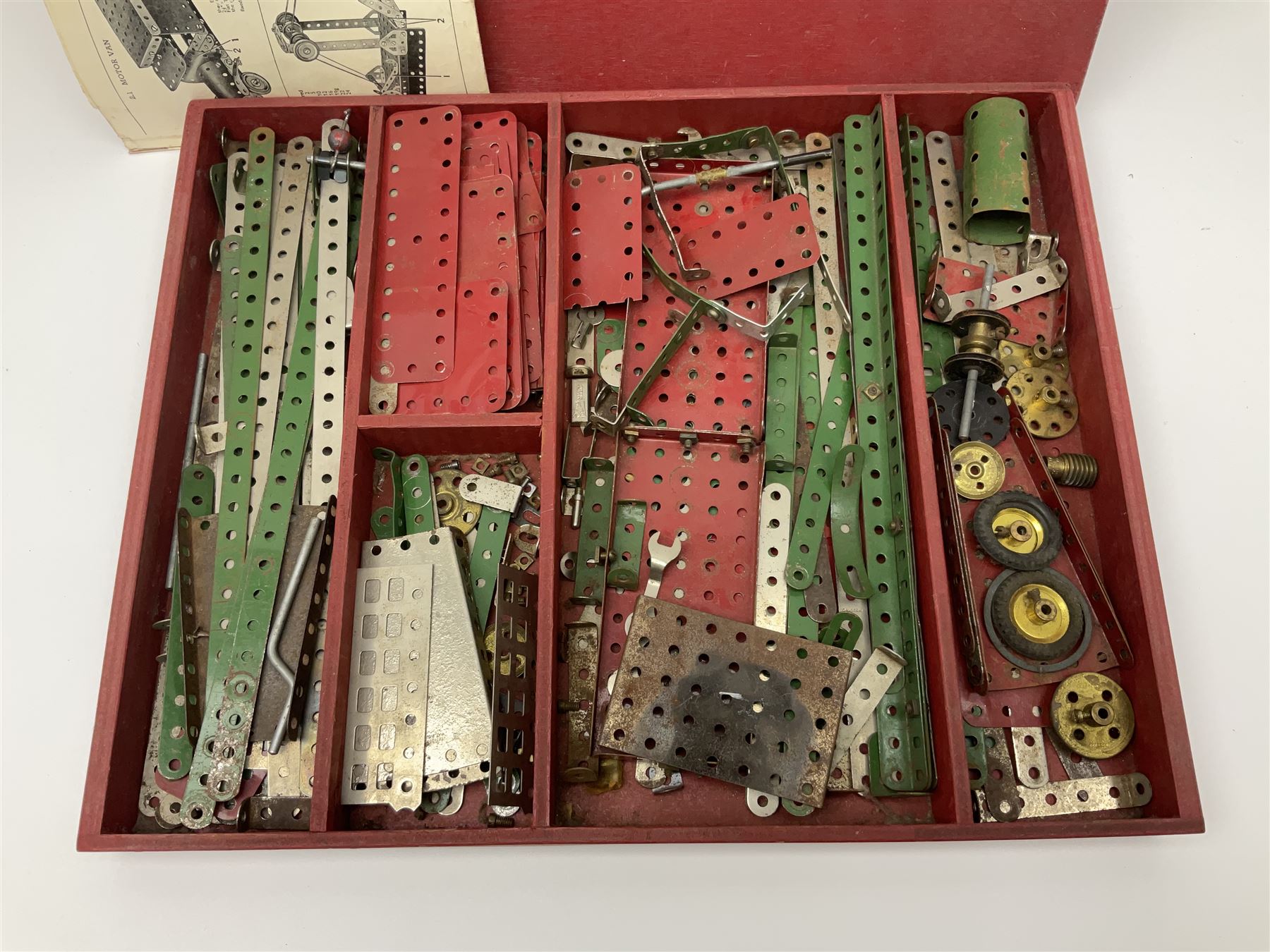 Meccano Set No.5 wooden box containing quantity of predominantly red and green sections, parts, brackets, wheels etc and instruction booklet