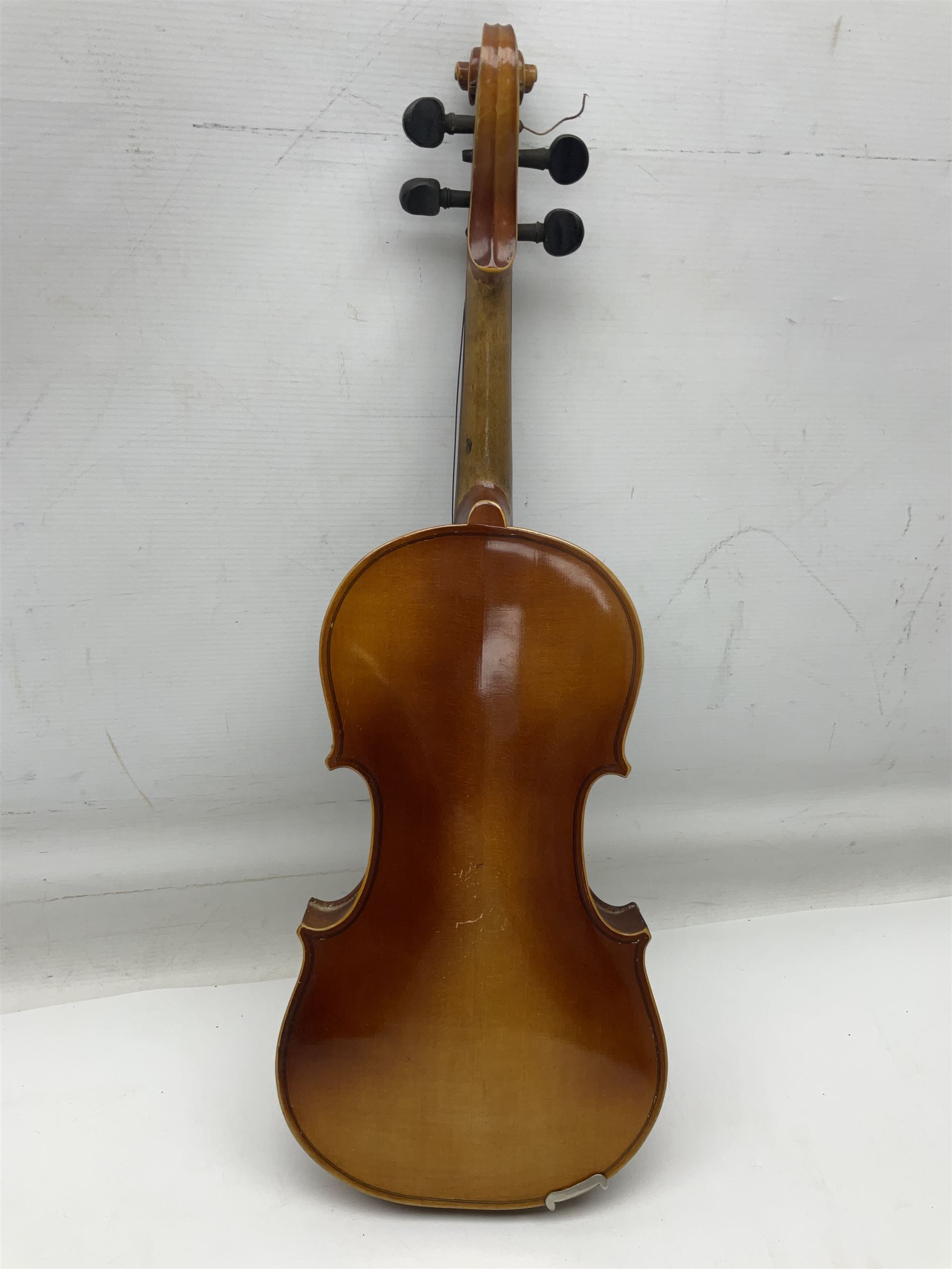 Czechoslovakian violin c1920 with 36cm two-piece maple back and ribs and spruce top, bears label 'Copy of Antonius Stradivarius Made in Czechoslovakia' L59cm; in carrying case; 1950s Czechoslovakian violin; and 195os Czechoslovakian three-quarter size violin; both cased (3)