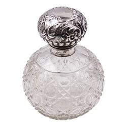 Victorian silver wine label for Brandy, of shaped form with engraved foliate detail, hallmarked George Unite, Birmingham 1859, together with a late Victorian/Edwardian silver mounted cut glass scent bottle, the glass body of spherical form with octagonal and hobnail cut decoration, the hinged silver cover embossed with flower heads and scrolls, opening to reveal an internal glass stopper, hallmarked Walker & Hall, Sheffield, date letter worn and indistinct, H13.5cm