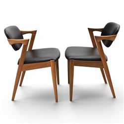 Kai Kristiansen (Danish c.1929-2022) - Pair of mid-20th century teak elbow chairs upholstered in black leatherette