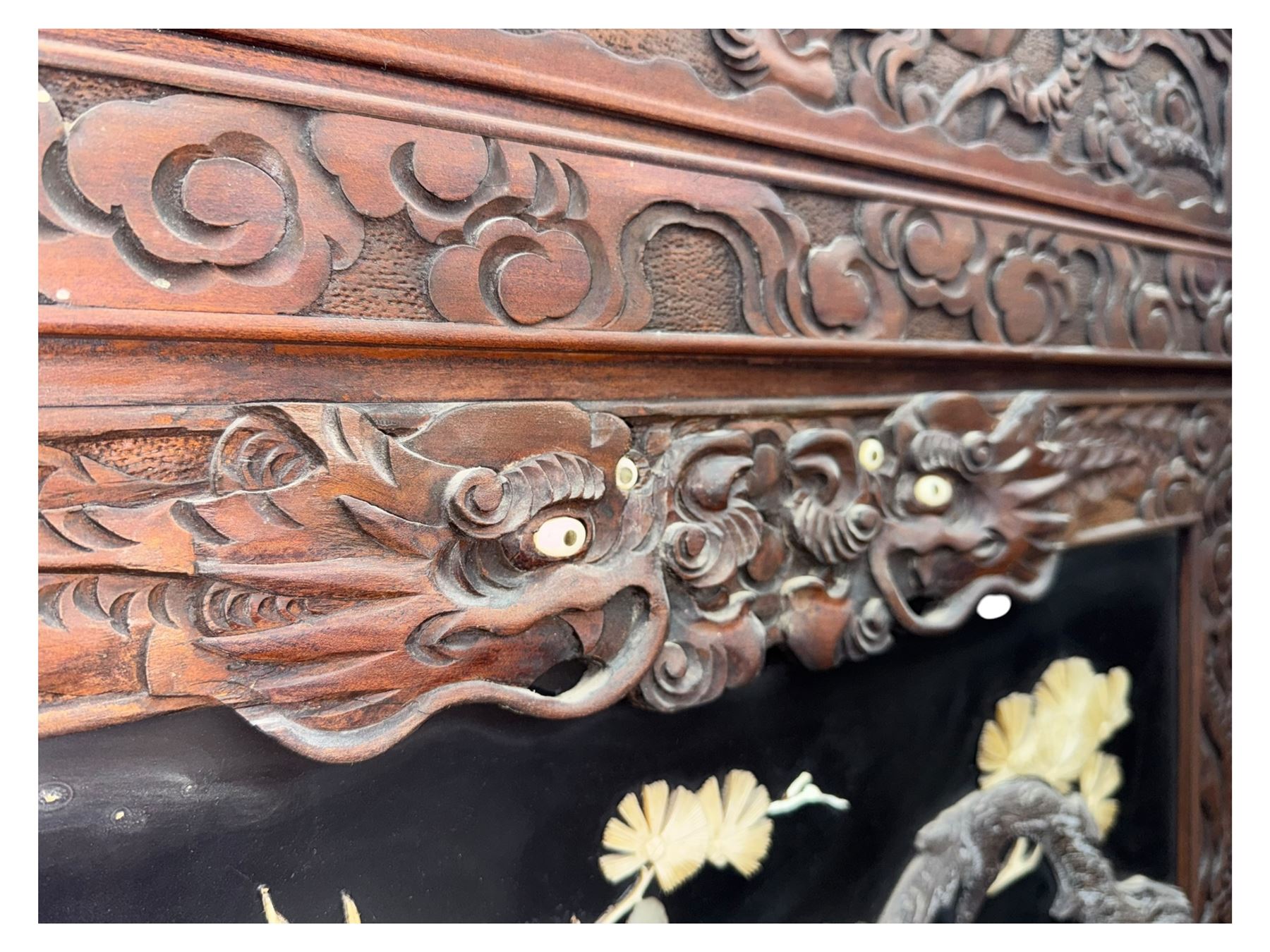 Meiji period (1868–1912), Shibayama lacquer carved hardwood two-fold screen inlaid with mother-of-pearl, bone, and ivory, decorated on one side in high relief and inlaid in a  Shibayama manner with oriental storks flying below flowering branches,  the reverse lacquer panels depicting flowering cherry trees. This item has been registered for sale under section 10 of the APHA Ivory Act.