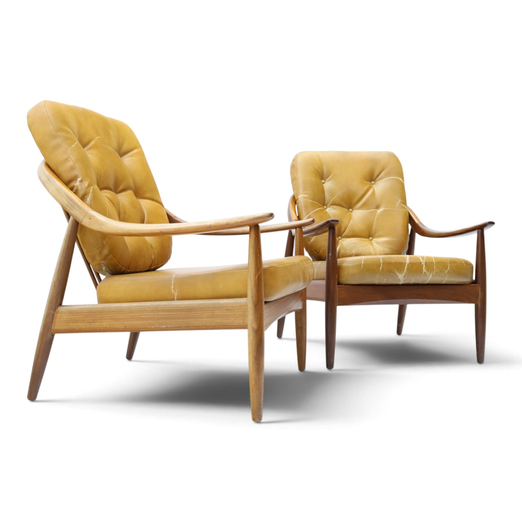 Greaves & Thomas - pair of mid-20th century light elm framed lounge armchairs, with downswept arms and a spindle back, webbing base with makers mark, tan brown leather seat cushions with button back detail