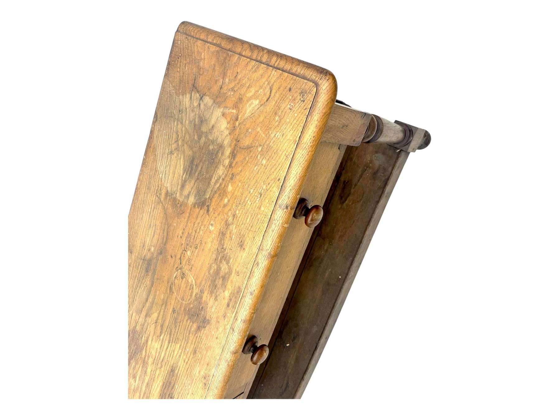 Late 19th century oak potboard dresser base, rectangular top over two frieze drawers with turned wooden handles, raised on four ring turned and tapering supports with block feet, united by a full-width lower potboard