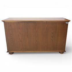 Ercol - elm dresser sideboard, fitted with four drawers and four cupboards with carved detail, drawer featuring cutlery slide