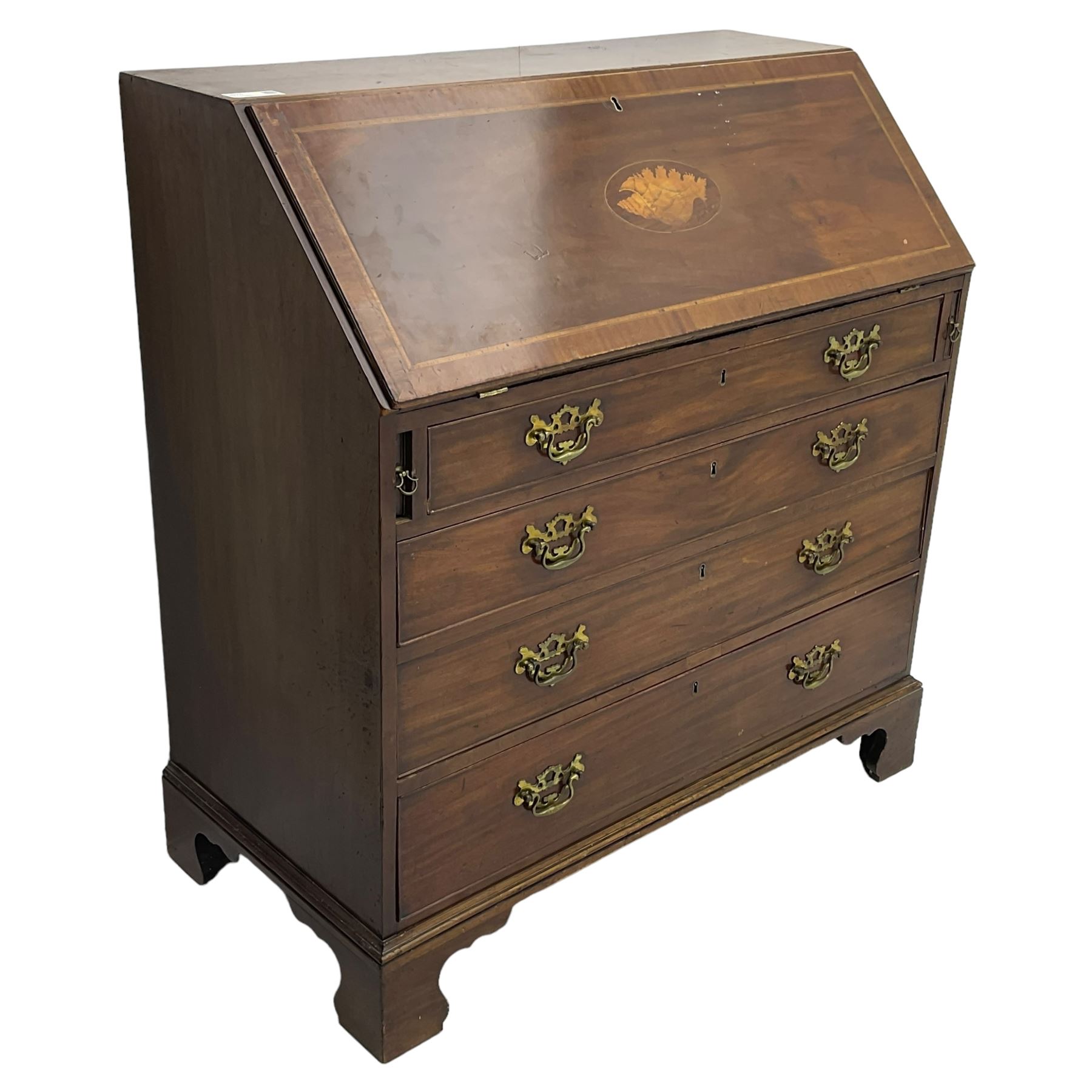 George III mahogany bureau, the conch inlaid fall front enclosing pigeon holes, shelves and central cupboard with inlaid flower motif, four graduating cock-beaded drawers below each with brass handles, lower moulded edge over shaped bracket feet