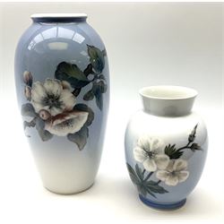 Two Royal Copenhagen vases, first example a vase of baluster form with apple blossom design on a pale blue ground, model no 2629 design no 2129 H27.5cm, second example a vase of ovoid form, with flower and butterfly decoration, model no 2667 design no 36 H17.5cm. 