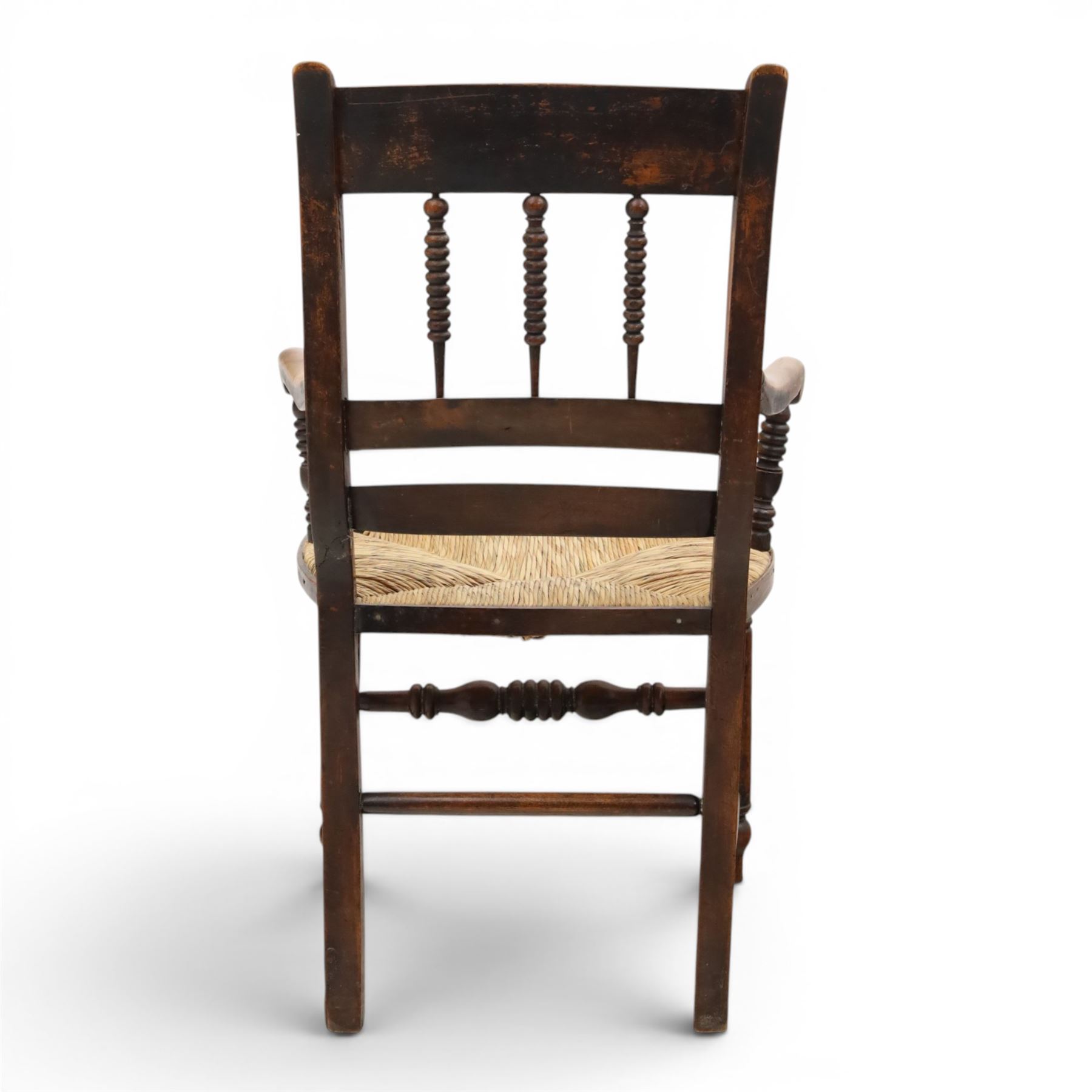 19th century elm chair, with curved top rail and bobbin turned spindles, woven rush seat, on turned legs united by front stretcher