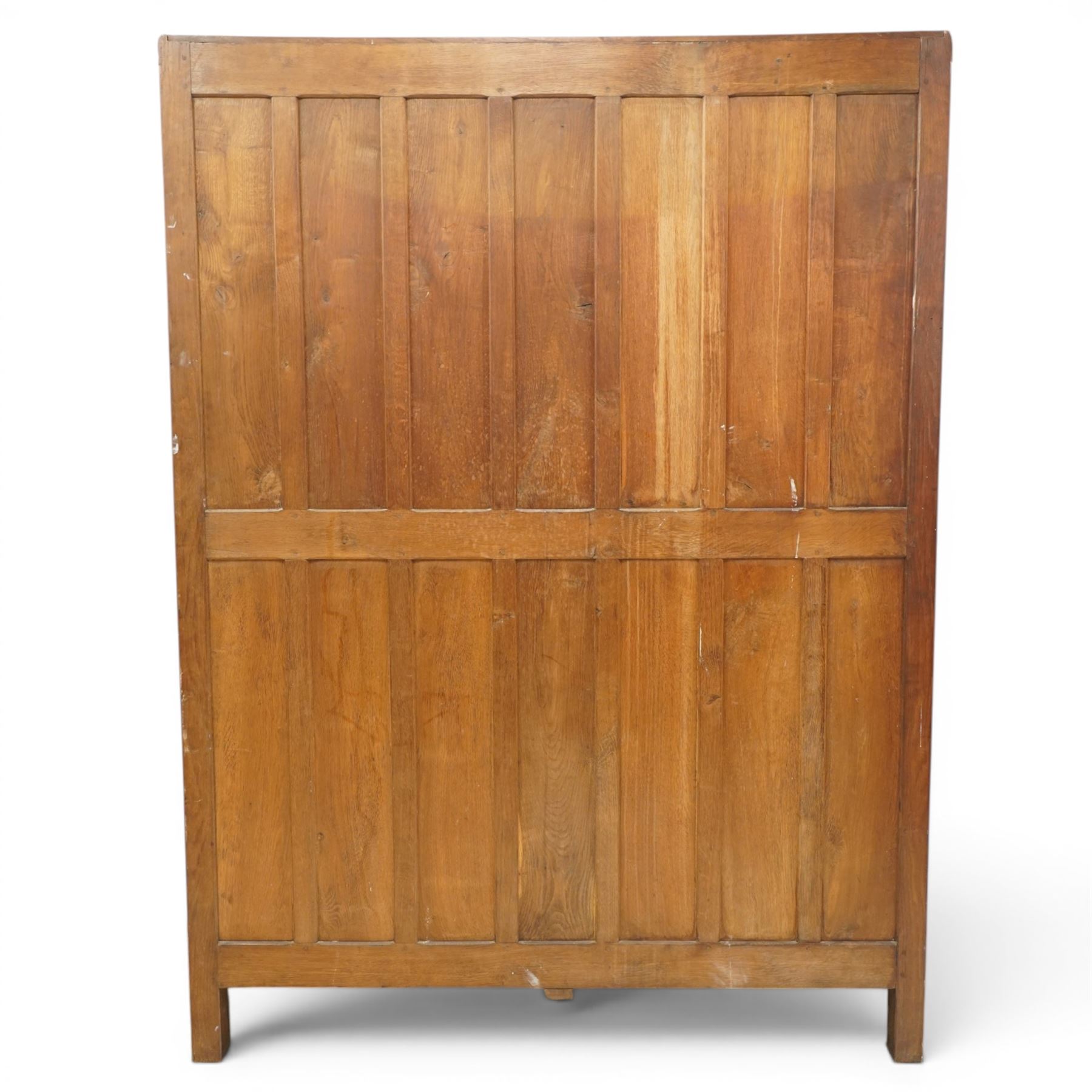 Mouseman - early-to-mid-20th century figured panelled and adzed double wardrobe of large proportions, the arcade carved cresting rail over two doors with adzed and figured oak panels, with wrought metal hinges and latch, relief carved mouse signature, the interior fitted with hanging rail, by the workshop of Robert Thompson, Kilburn