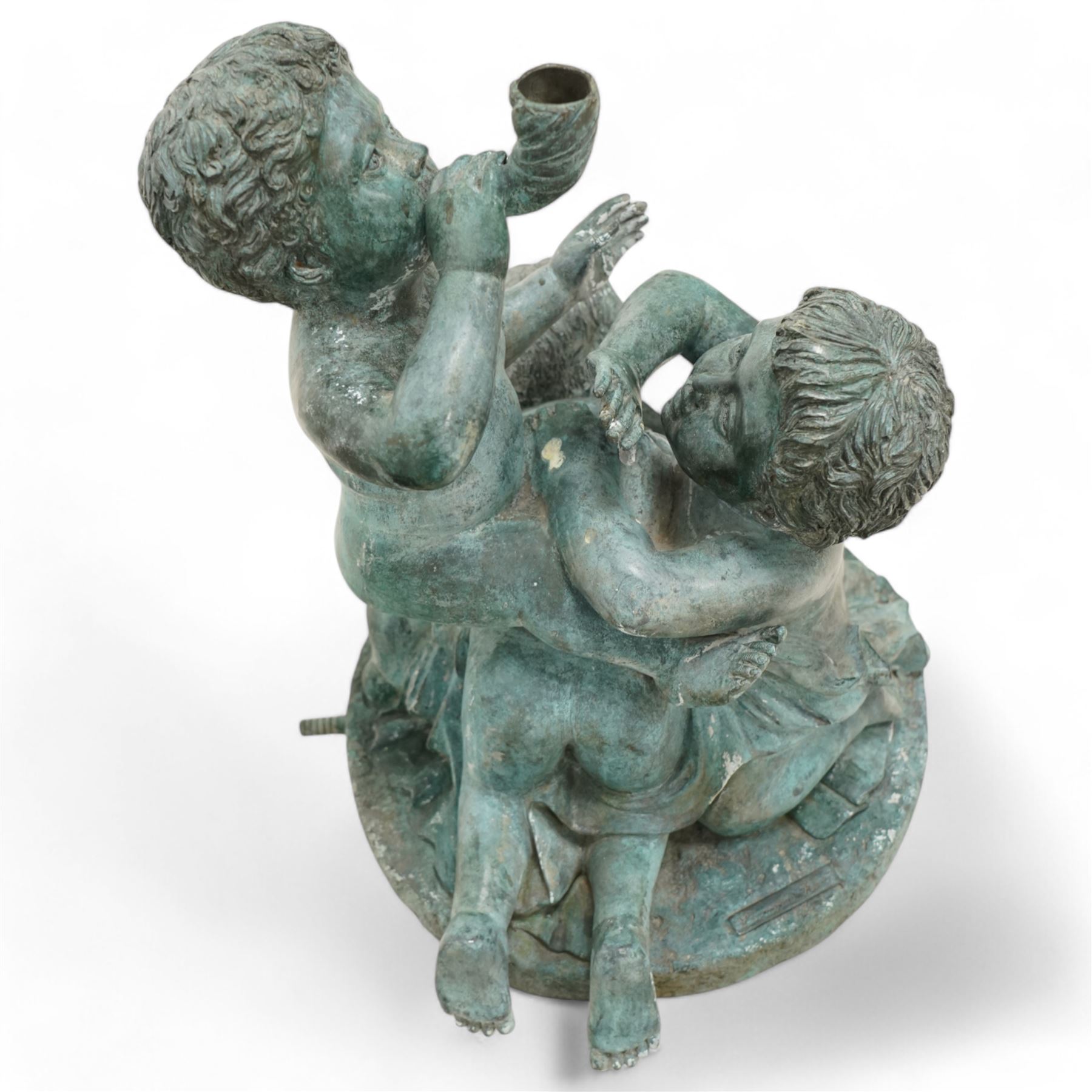 Cast bronze garden water fountain in the form of three Putti on circular naturalistic base, stamped 'Leonardo Rossi'  
