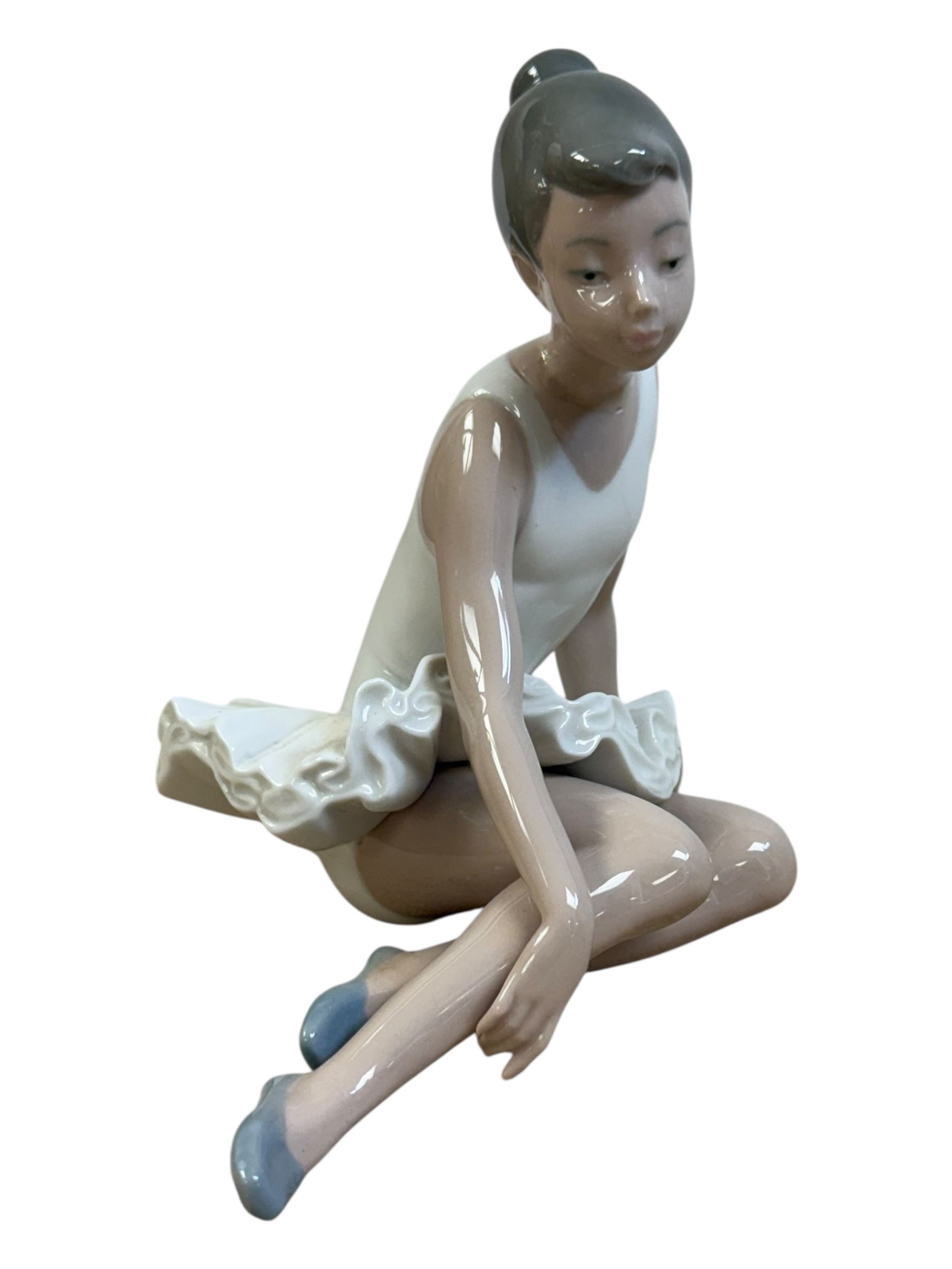 Three Lladro figures, Bashful Bather 5455, Pepita no 5372 and girl with lamb no 1010, together with two Neo figures and a Royal Doulton figure 