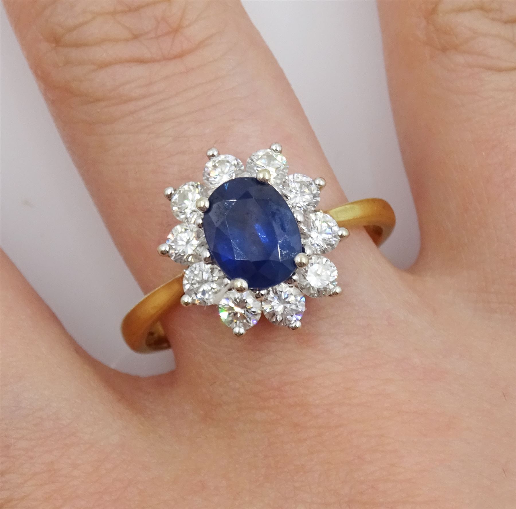 18ct gold oval sapphire and round brilliant cut diamond cluster ring, hallmarked, sapphire approx 1.40 carat, total diamond weight 0.98 carat