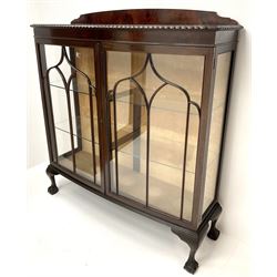 Early 20th century mahogany bow front display cabinet, raised shaped back, two doors enclosing two lined shelves, cabriole legs on ball and claw feet 