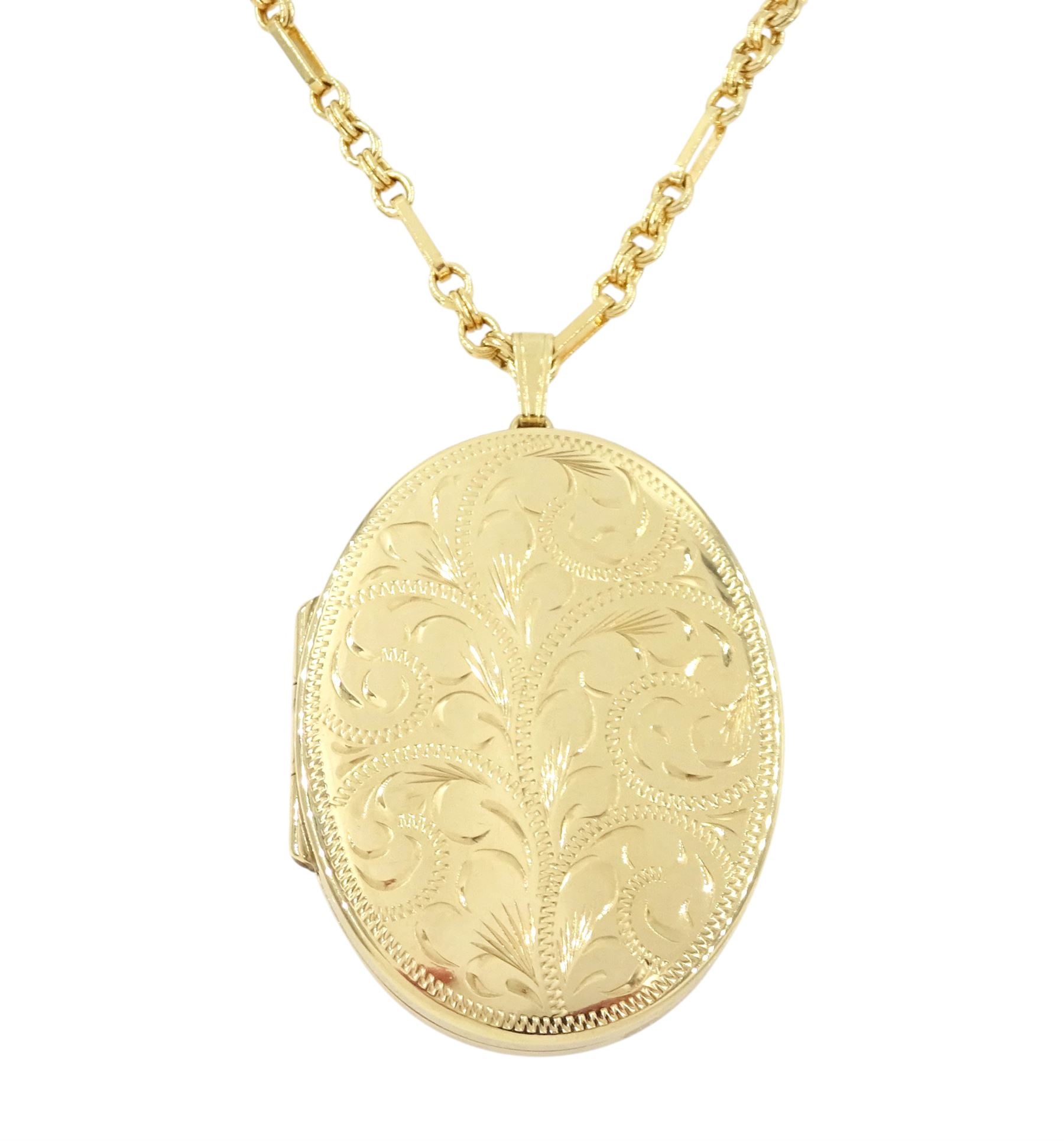 Gold oval locket with engraved decoration, on a gold fancy link chain, both 9ct, hallmarked 