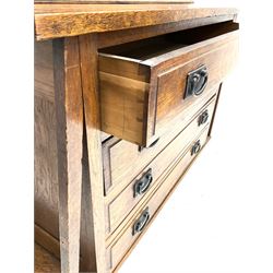 Arts & Crafts oak cabinet on chest, projecting cornice above to lead glazed cabinet doors, two shelves flanking single fall front enclosing fitted interior, four graduating drawers