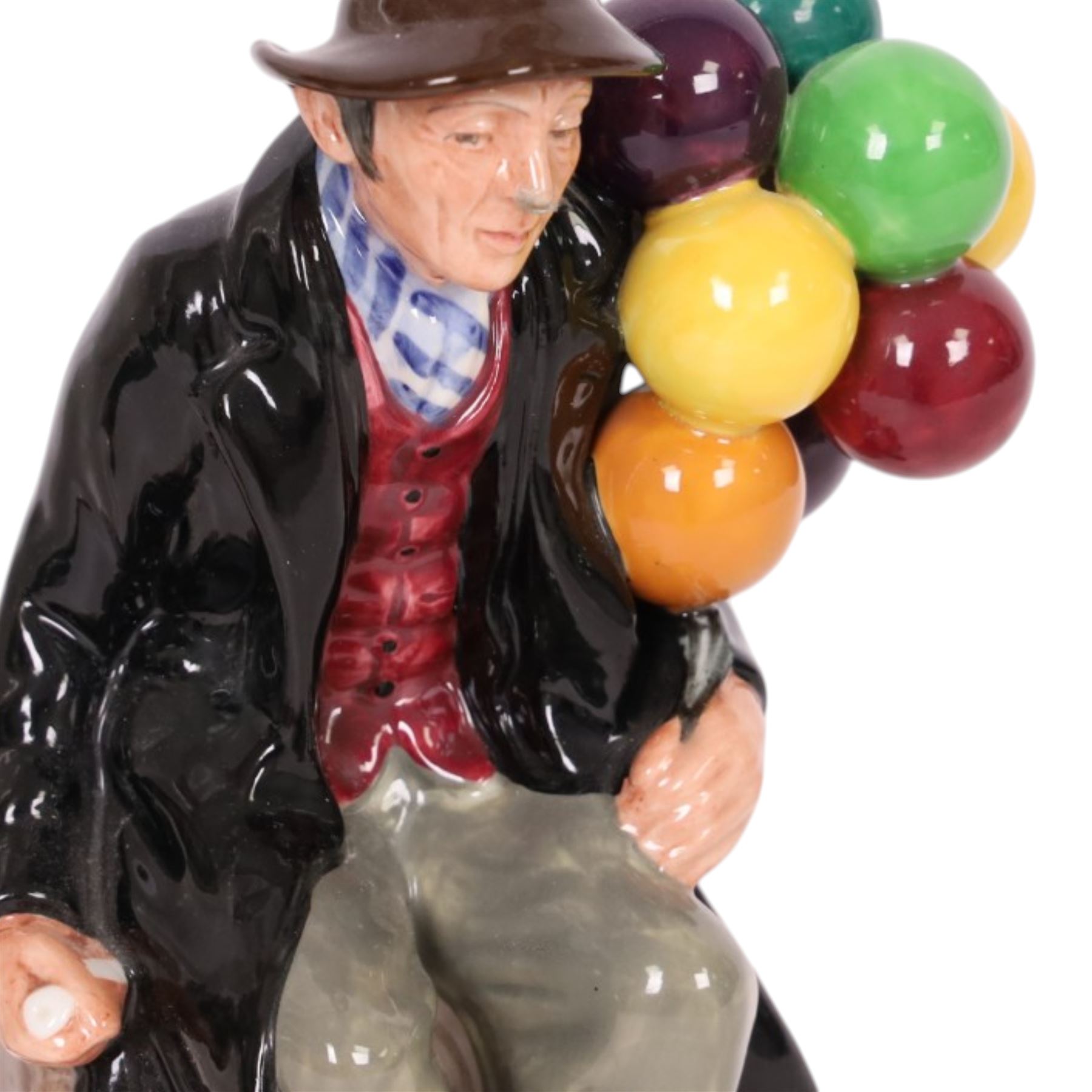 Three Royal Doulton figures, comprising  Churchill HN3057, The Old Balloon Seller HN1315 and The Balloon Man HN 1954