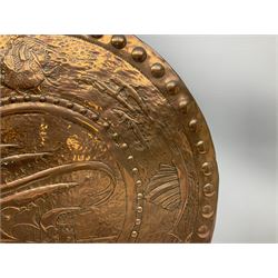 Large Arts and Crafts Newlyn School copper charger, repousse decorated with galleon to the centre surrounded by a continuous band of fish, D63cm