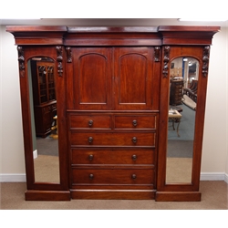  Victorian mahogany triple wardrobe, moulded projecting cornice, two full length mirrored wardrobe doors flanking two cupboard doors above two short and three graduating drawers, plinth base, W238cm, H211cm, D60cm  