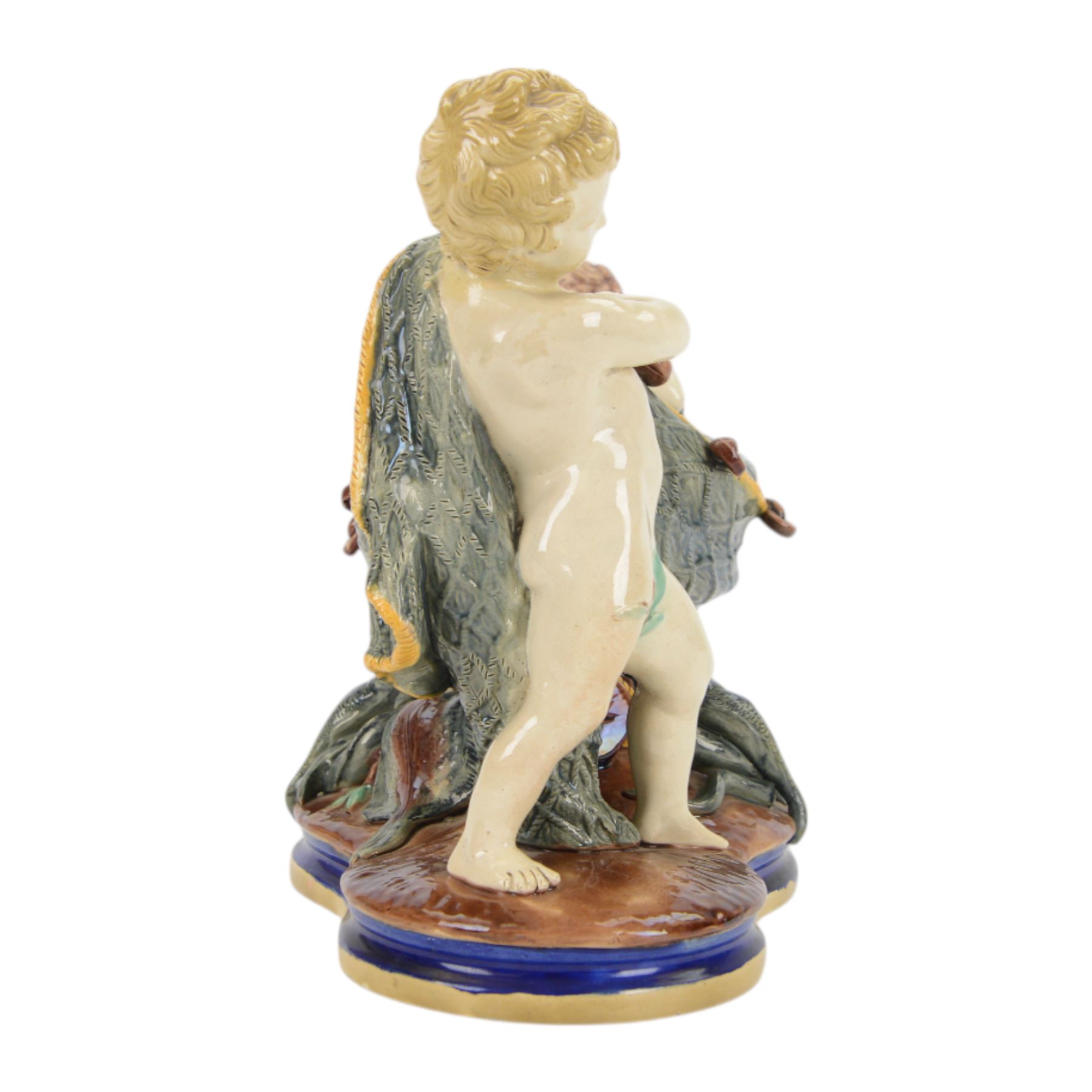 Late 19th century Copeland majolica centrepiece, circa 1874, modelled as two putto standing with fishing net draped between them, their catch spilling onto the quatrelobed base beneath, with impressed mark beneath, H24cm W33cm 