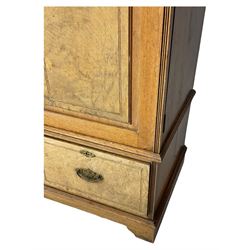 Late Victorian walnut triple combination wardrobe, projecting moulded and dentil cornice, central shaped bevelled mirror glazed door, cartouche and curled leaf carved panels over figured walnut veneered panels, fitted with drawer to base, on bracket feet