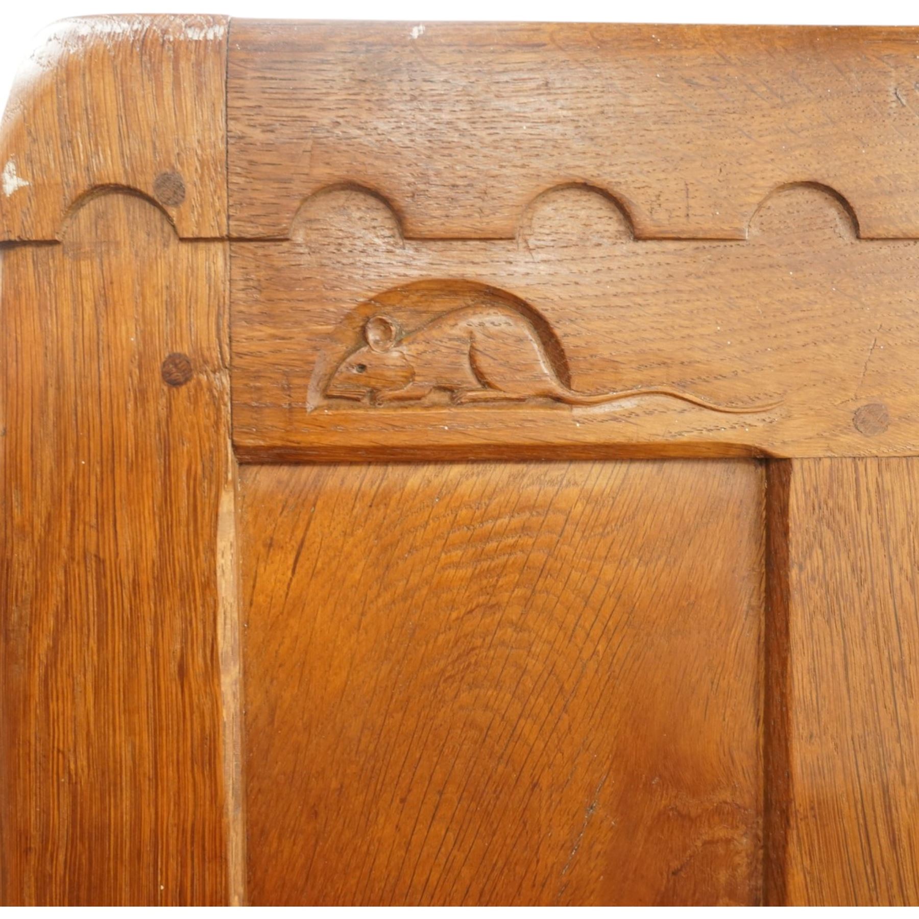 Mouseman - early-to-mid-20th century figured panelled and adzed double wardrobe of large proportions, the arcade carved cresting rail over two doors with adzed and figured oak panels, with wrought metal hinges and latch, relief carved mouse signature, the interior fitted with hanging rail, by the workshop of Robert Thompson, Kilburn