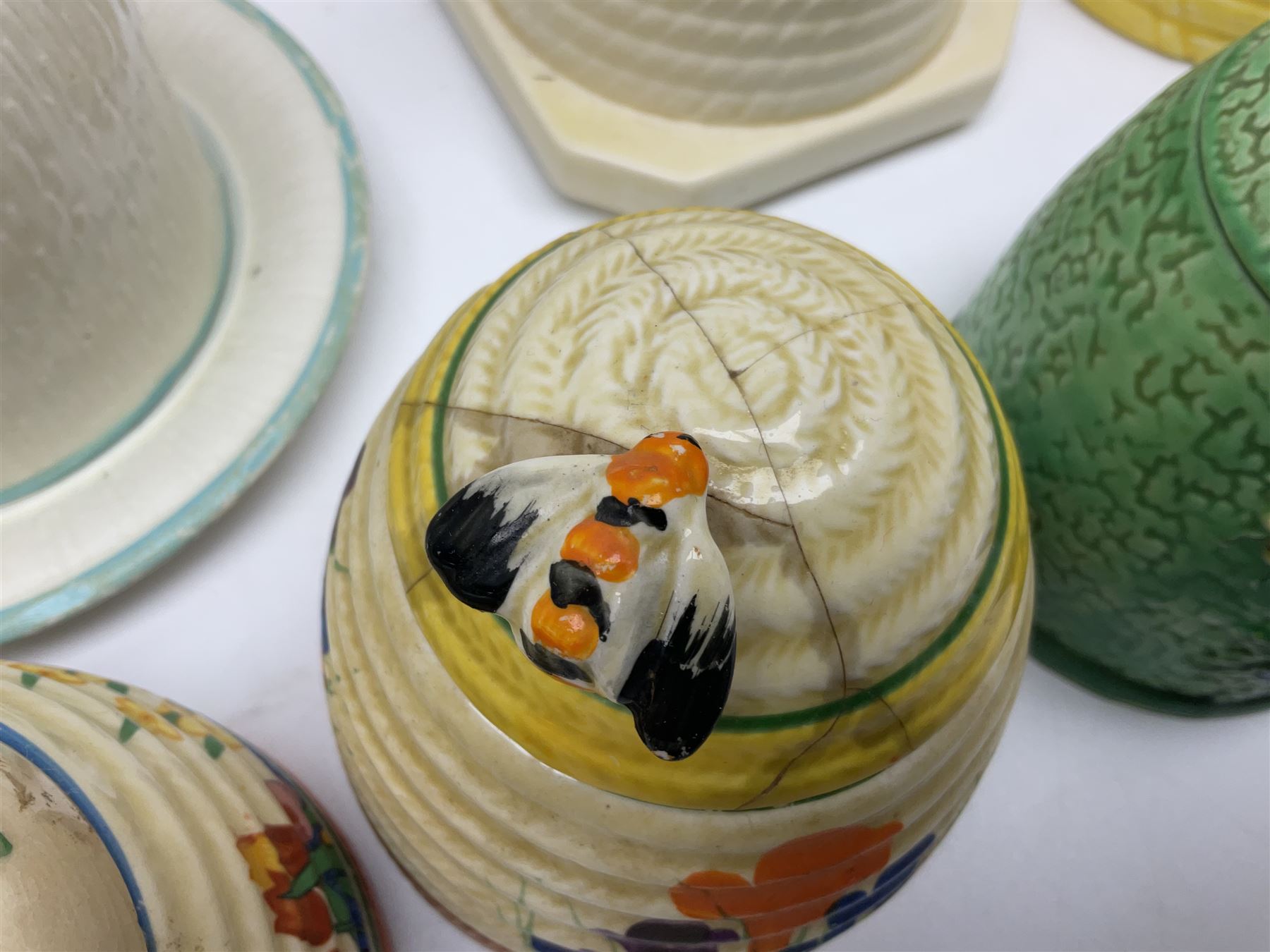 Clarice Cliff for Wilkinson Ltd Crocus Bizarre beehive honeypot painted in the Crocus pattern, together with two beehive Beswick honey pots, Poole square honey pot etc (14)