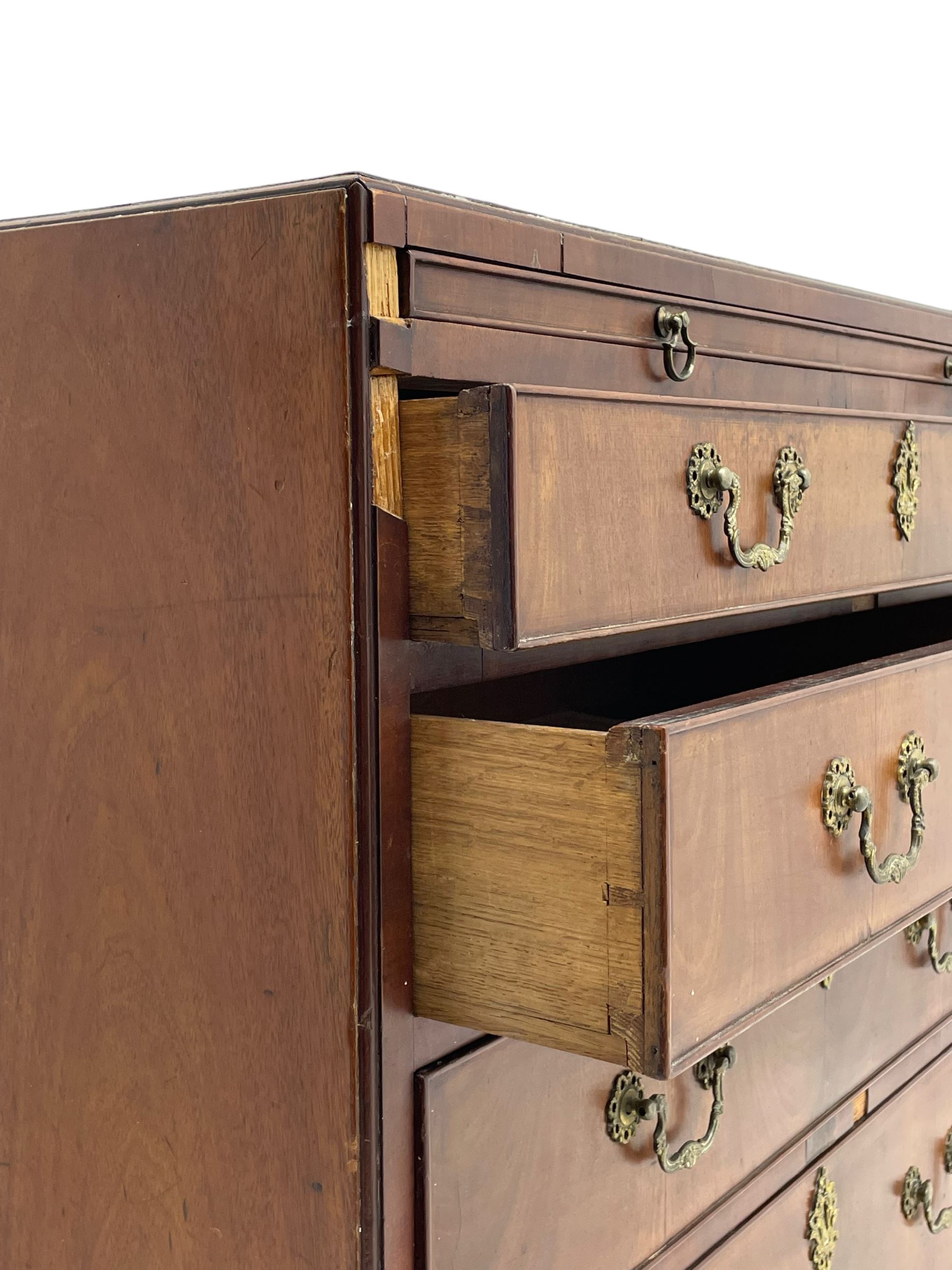 George III mahogany chest, banded caddy top with moulded edge, brushing slide over four graduating cock-beaded drawers, ornate cast gilt metal handle plates and escutcheons, swan neck handles cast with dolphins, shells and C-scrolls, lower moulding over bracket feet