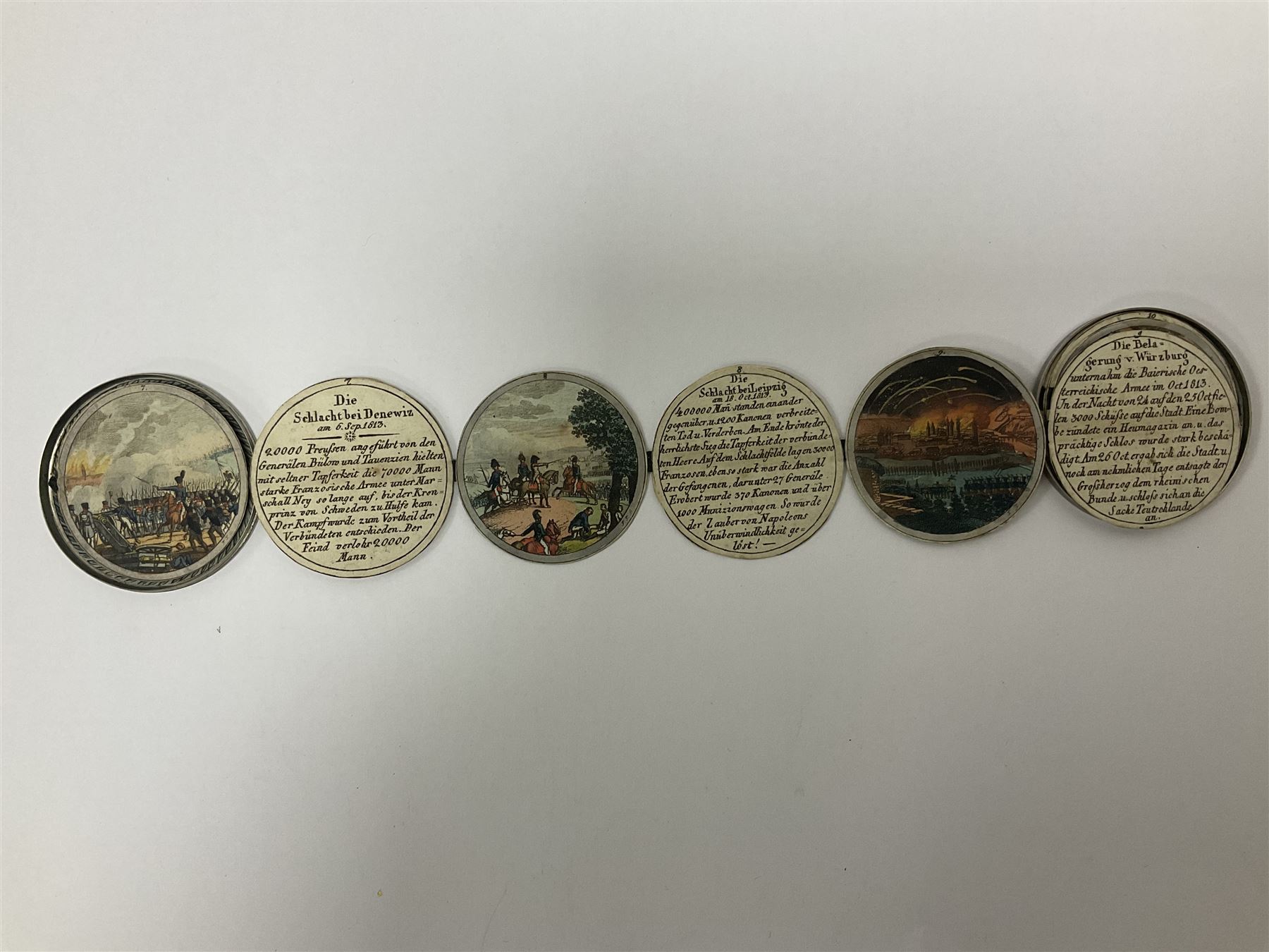 Grolier Club’s silver Schraubmedaille to commemorate the German campaign of 1813, obverse depicts a Greek temple, below “Eintracht Überwindet Alles”, the reverse depicts three figures and the text “Gerechtigkeit. Weisheit. U. Einigkeit. Beglücken. D.: Menschheit”, inside are twelve circular hand coloured engravings depicting six major battles of the German campaign, each with corresponding descriptions, D