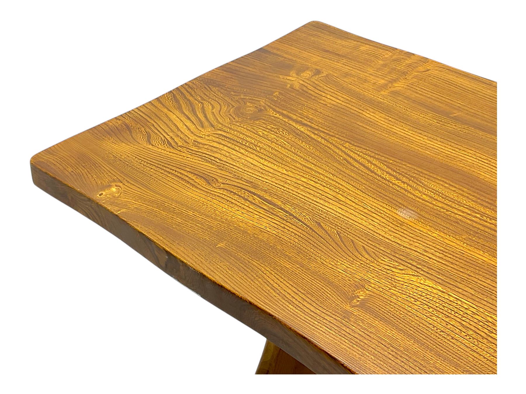 Late 20th century oak trestle table, rectangular top with naturalistic edge, supported by two curved pedestal bases united by central stretcher, on block feet
