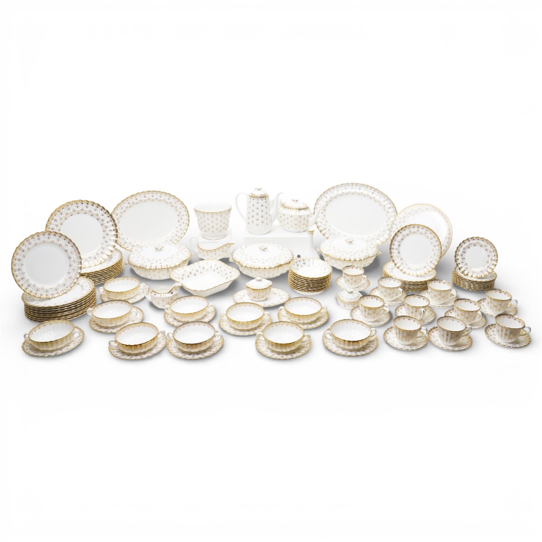 Spode Fleur de Lys tea and dinner service for ten, comprising dinner plates, side plates of graduating sizes, bowls, twin handled soup bowls, three covered dishes, sauce boat and saucer, two serving dishes, open serving dish, teapot, coffee pot, milk jug, covered sucrier, cake plate, vase, jardiniere, cups and saucers