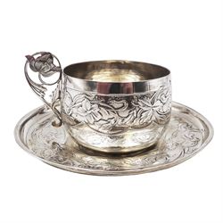 French silver cup and saucer, with embossed floral decoration throughout and openwork floral handle, stamped with Minerva's head and maker's mark for 	P. Fres Paris, cup H5.5cm