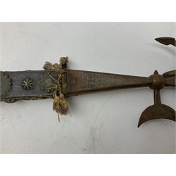 Eastern ceremonial or processional halberd, the square section hardwood handle studded and mounted all over with coins from various countries L85cm