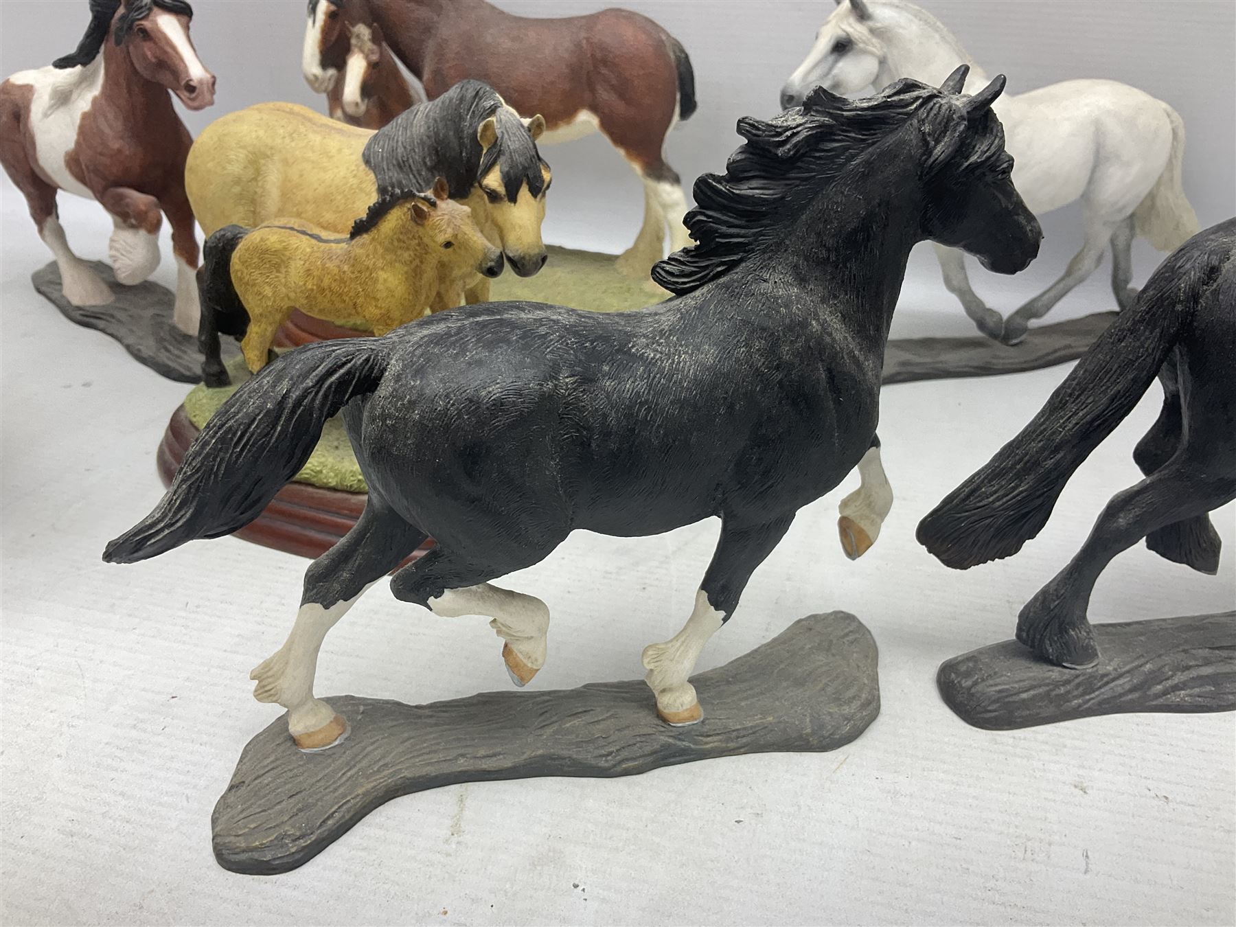 Seven Border Fine Arts figures, comprising Clydesdale Mare & Foal A0187, Highland Mare & Foal A2691 and five horses from the Action Horses series 