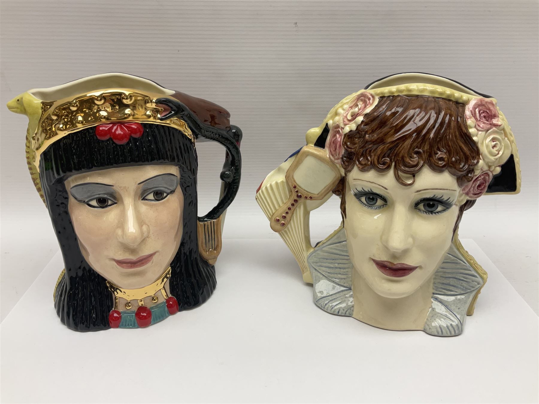 Royal Doulton two character jugs from the Star Crossed Lovers Collection, Antony & Cleopatra D6728 and Napoleon & Josephine D6750, together with two Royal Doulton Figures Micawber and Sairey Gamp