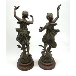 A pair of spelter figures, after Guillemin, Le Message, and Ondine, one example holding a dove and envelope aloft, the other holding a lyre and flower, largest H40cm.