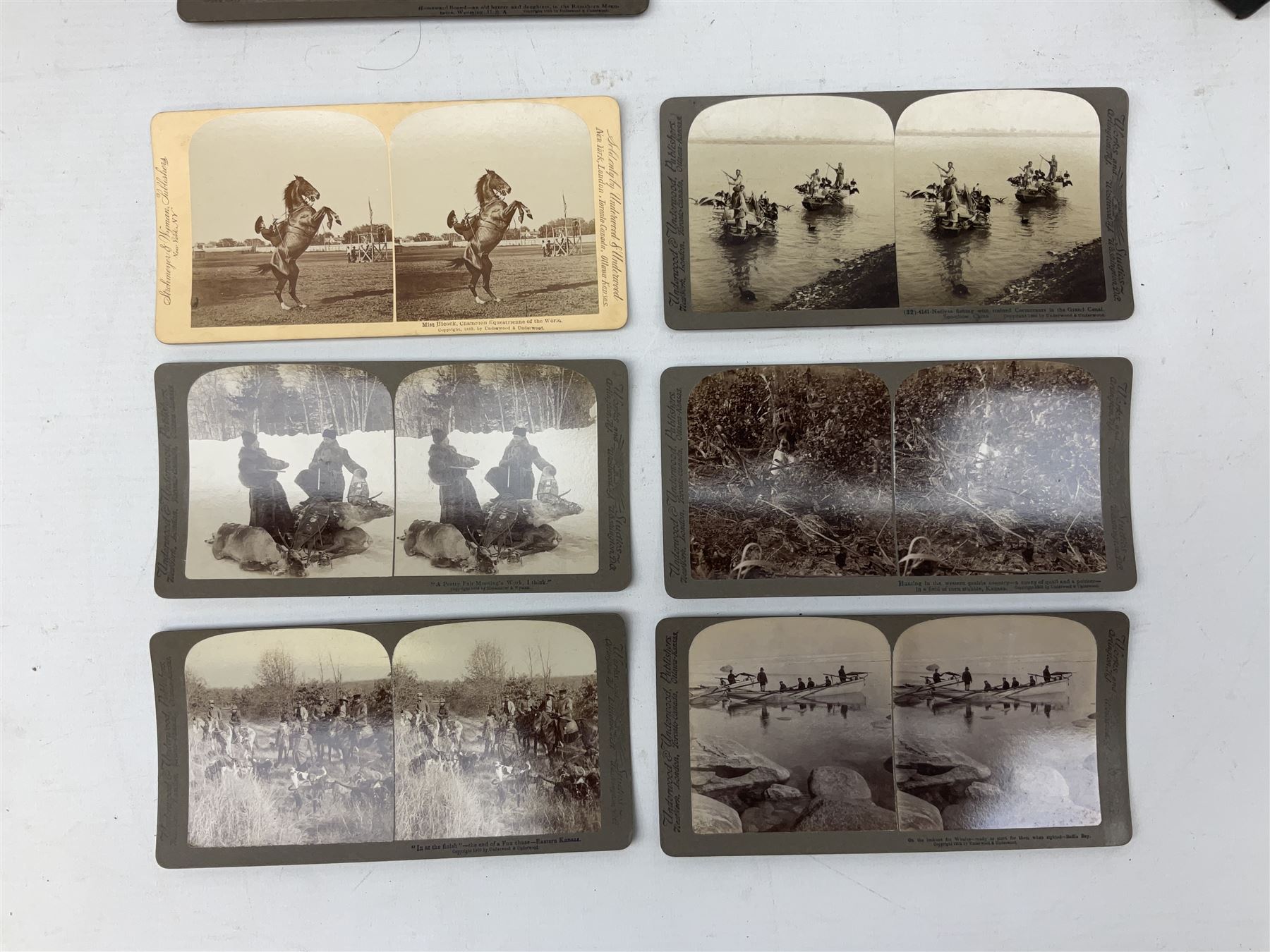 Early 20th century hand held slide action stereoscope viewer, Underwood & Underwood, publishers: The South African War through the stereoscope, stereo photographs mounted on card and captioned, in two double volume book form boxes with title labels and Underwood & Underwood  publishers: Hunting series through the stereoscope, stereo photographs mounted on card and captioned, in a single volume book form box   