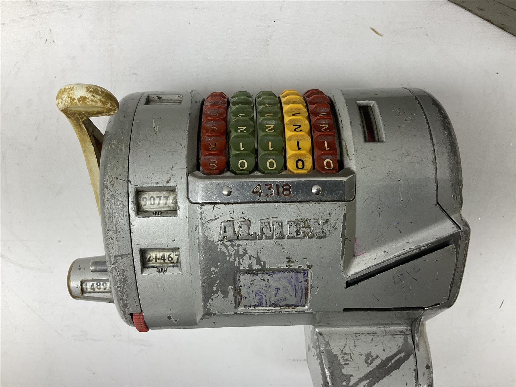 Bell Punch Company of London 'The Ultimate' five lever fare collection machine, together with an Almex ticket machine with shoulder strap, two brass Halifax transport cap badges, other chrome tramway cap badges, etc