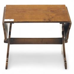 Early 20th century oak drop leaf cottage table, rectangular top with twin hinged leaves, on shaped trestle end supports united by central stretcher