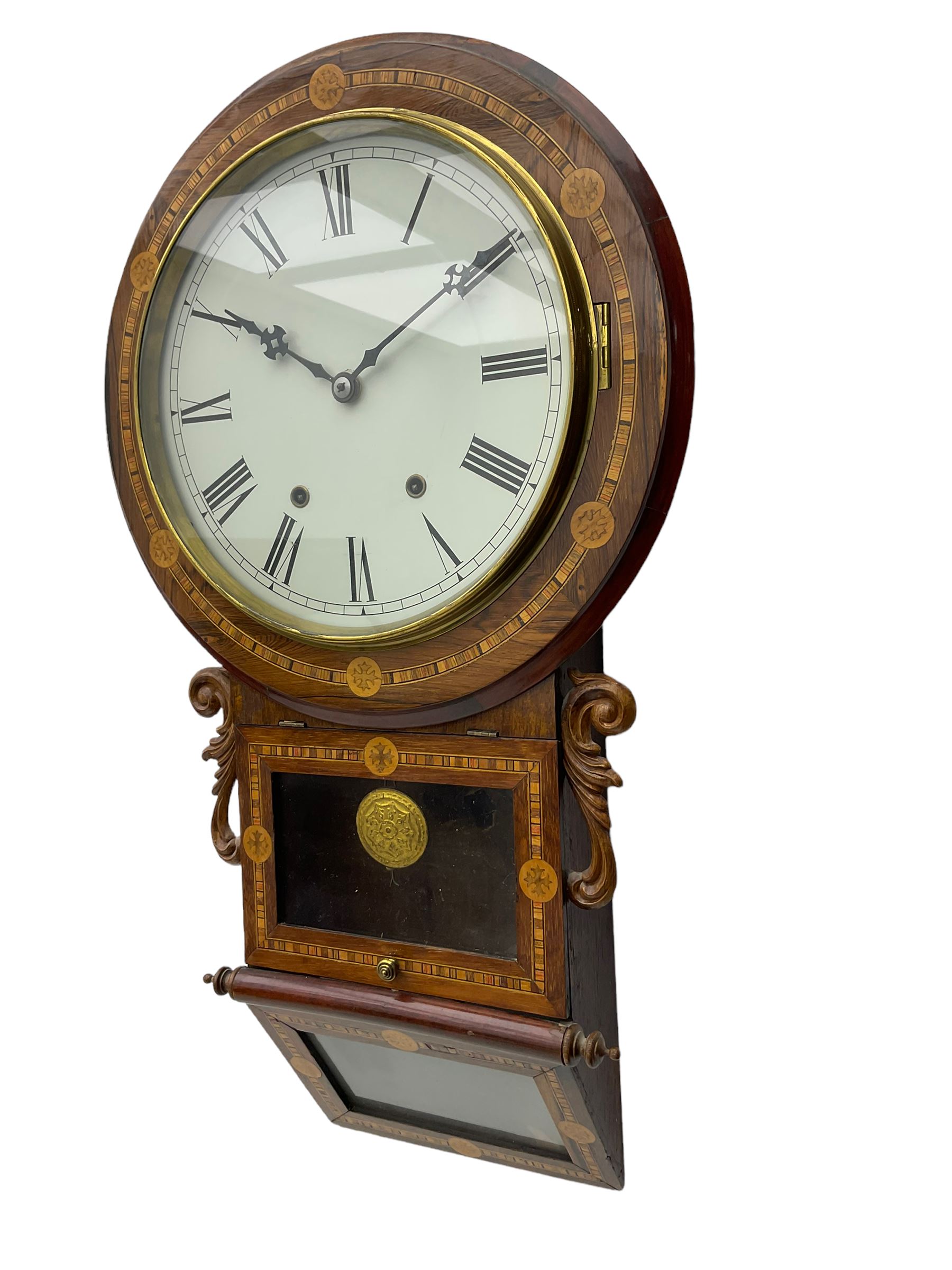 An American 'New Haven' late-19th century wall clock in a Rosewood case with parquetry inlay, carved 'ears' flanking the glazed pendulum viewing door with a glazed sloping base beneath, 12