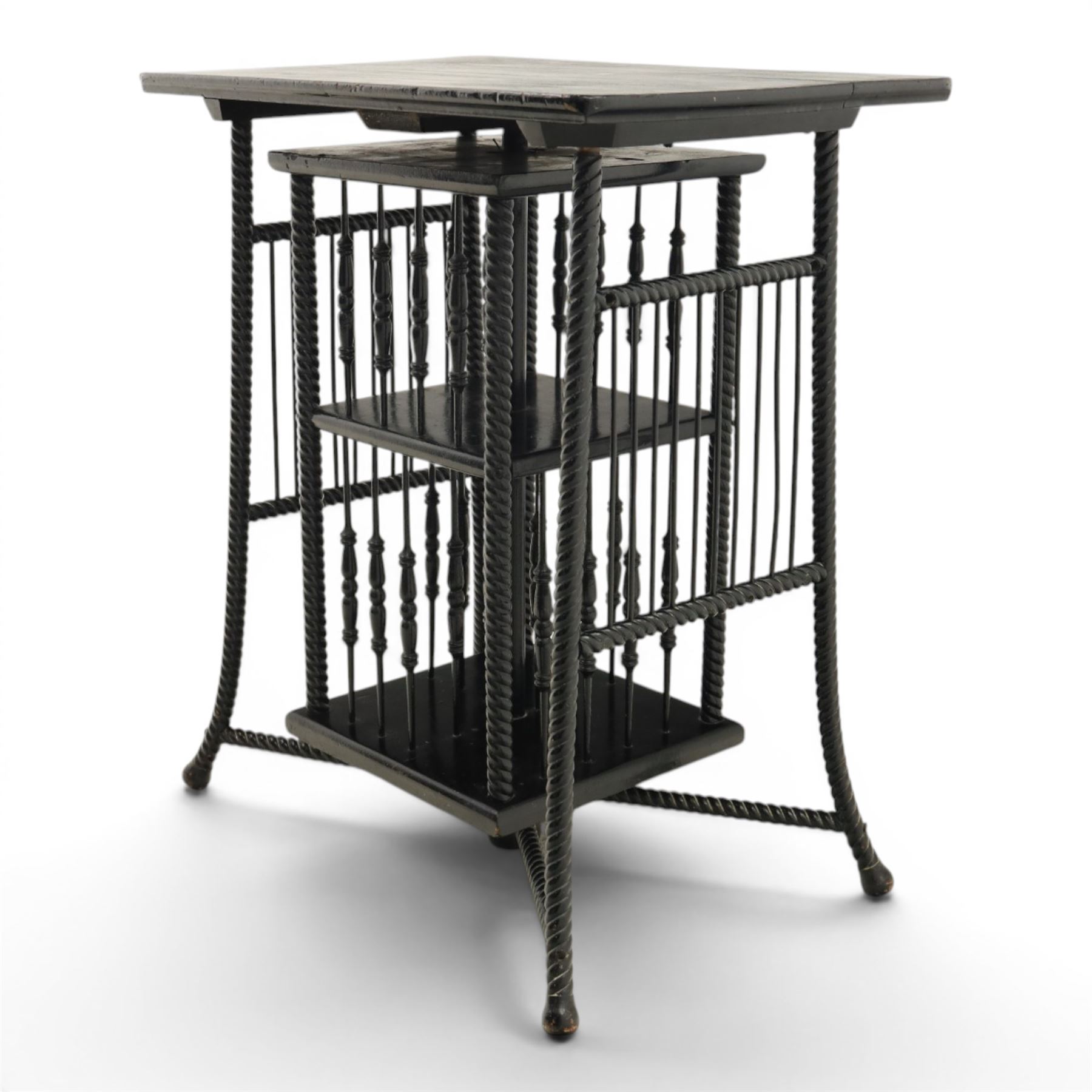 Edwardian black painted side table with incorporated revolving bookcase, supported on barley twist legs